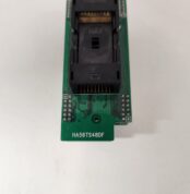 Close-up of an electronic circuit board with a black connector and labeled text.