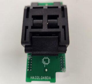 A black electronic component mounted on a small green circuit board.